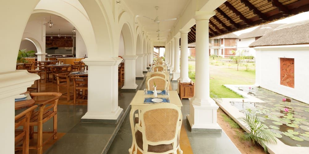 Smaak covered veranda with white arches overlooking the gardens