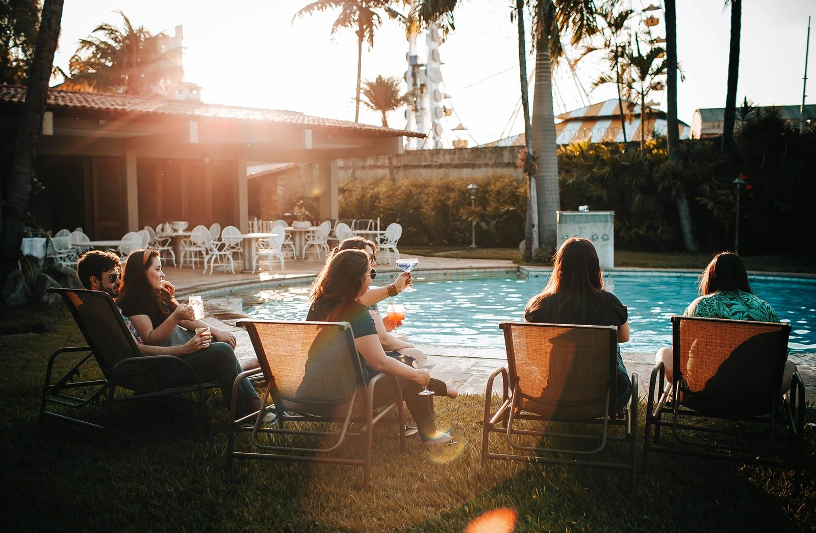 Lounge chairs beside the pool at sunset