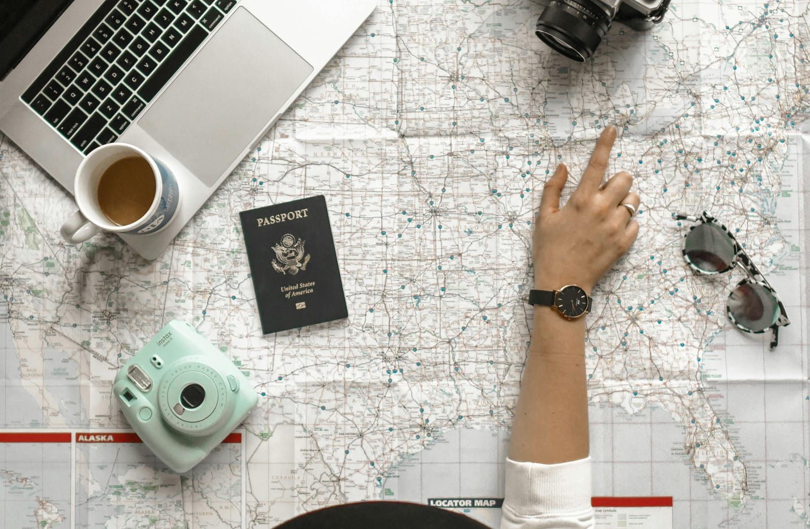 Map, passport and camera on a travel desk