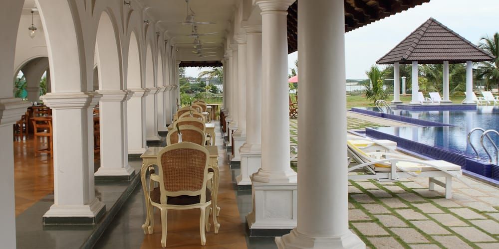 Smaak poolside veranda with dining tables and white pillars