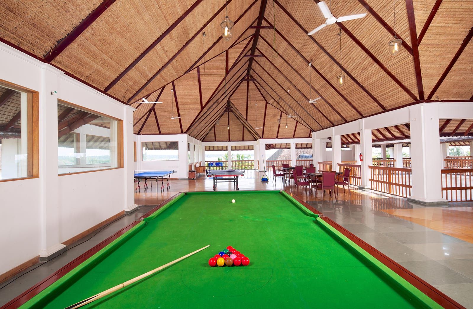 Games room with a pool table under a vaulted wooden ceiling